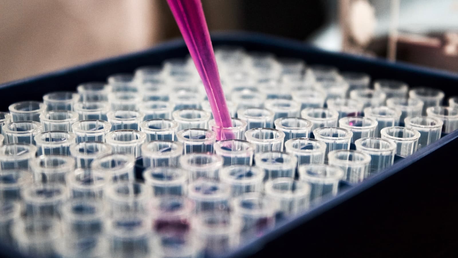 Sterile vials and a syringe arranged on a clinical surface, representing compounded peptide therapy under medical supervision.