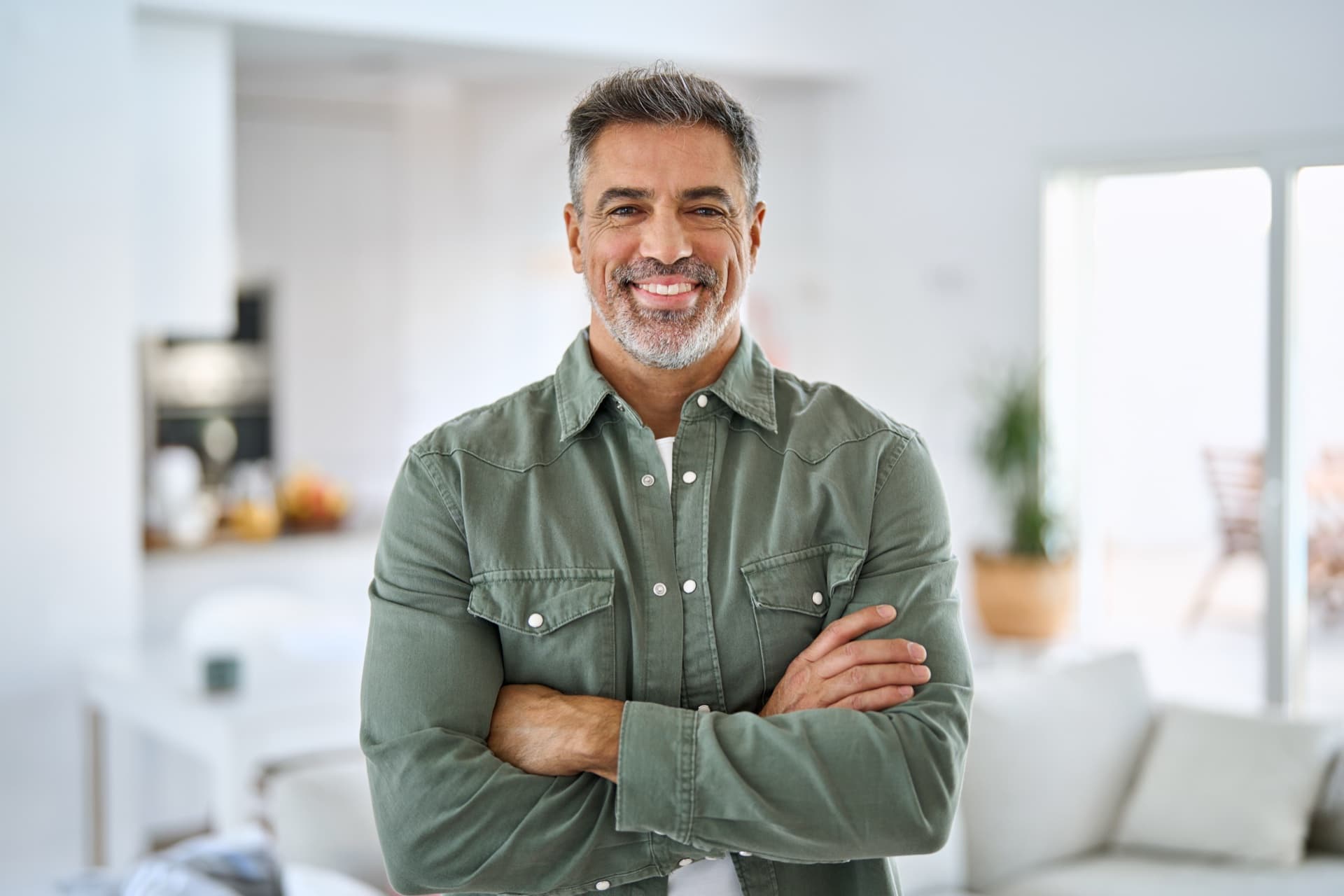 Man in his 40s training in a sunlit gym, representing strength and vitality associated with healthy testosterone levels.